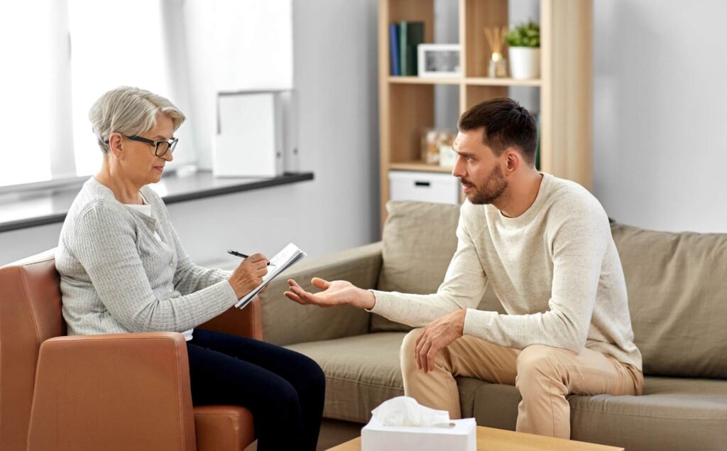 Man engaged in a DBT session in Denver.