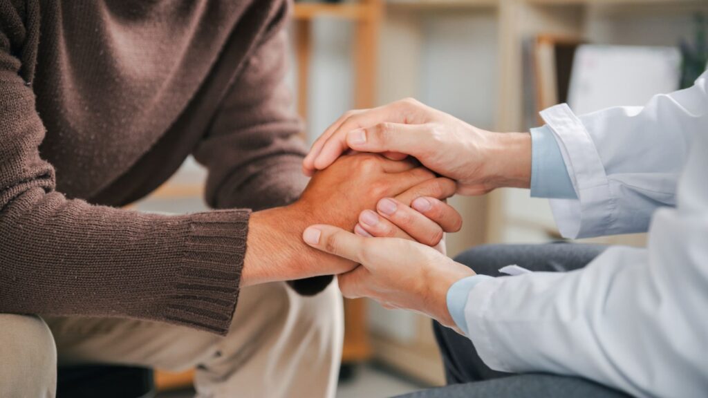 A man gets professional support at a drug rehab in Denver.