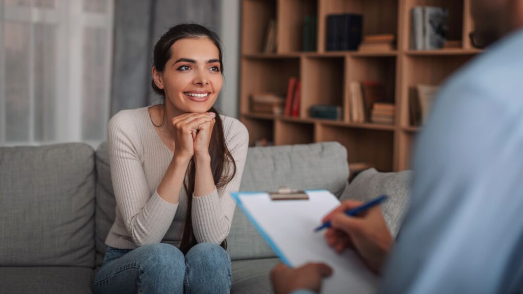 A hopeful woman talks to a therapist about rehab in Denver Medicaid.