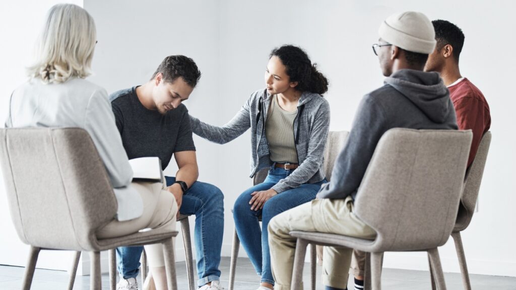 A man shares his experience during a group treatment exercise.