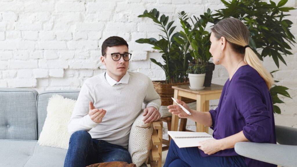 A man discusses past trauma during personalized treatment.